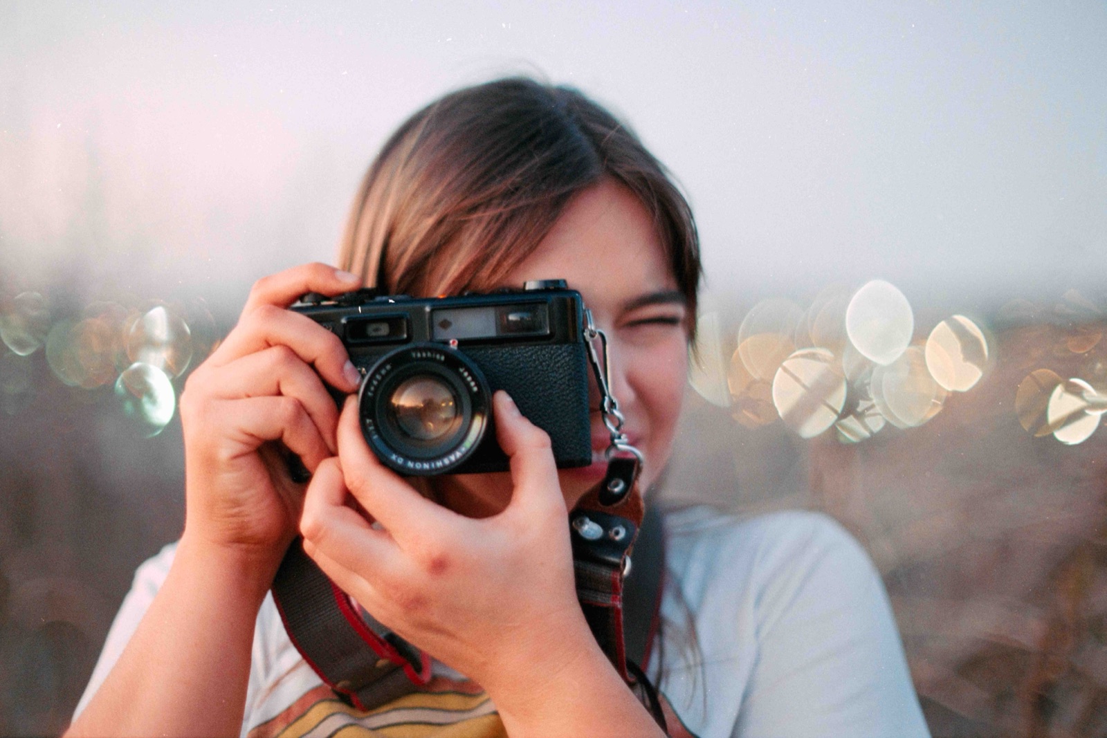 Senior taking a photo with a film camera