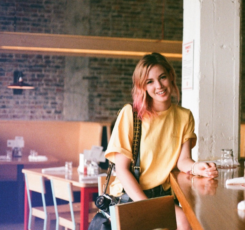 Smiling senior portrait in an Austin cafe