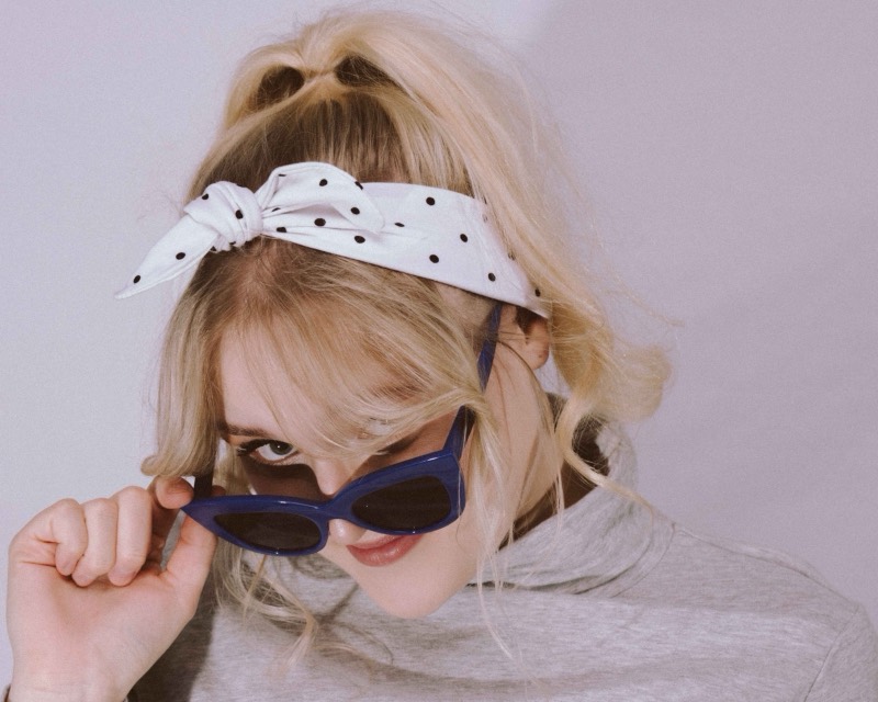 Playful studio senior portrait with sunglasses