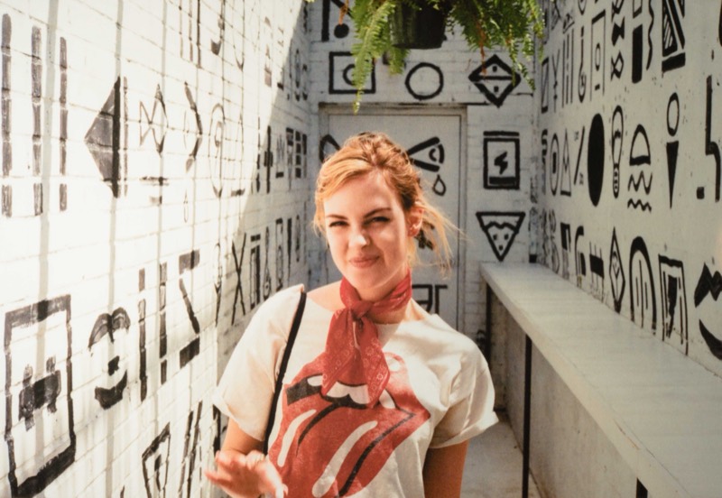 Editorial senior portrait in a graffiti hallway