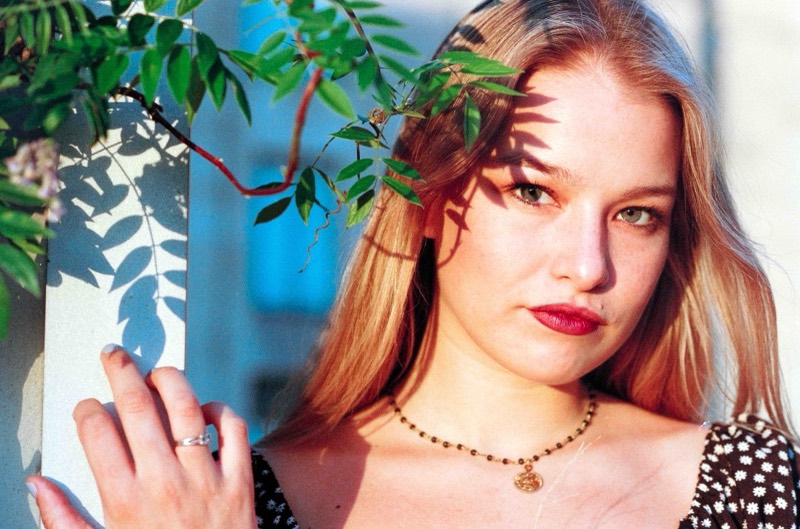 Natural-light senior portrait through leaves